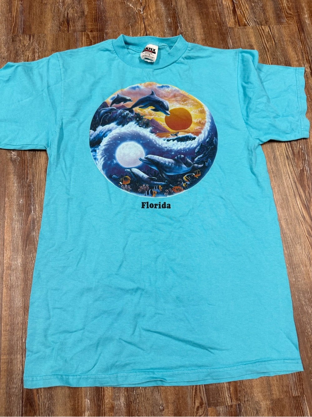 Vintage 90s Florida dolphin graphic tee with dolphins leaping over waves